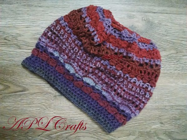 A Free form crocheted hat that has the feel of a slouchy hat, and can be worn like a slouchy hat, or a tube hat.
