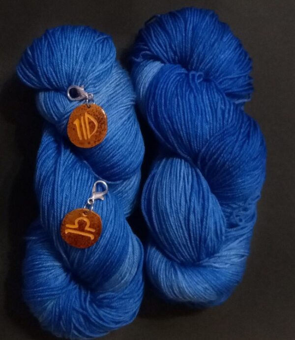 yarn in september birthstone color with zodiac charms