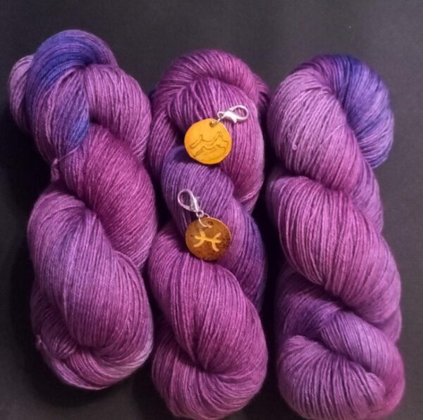 yarn in february birthstone color with zodiac charms